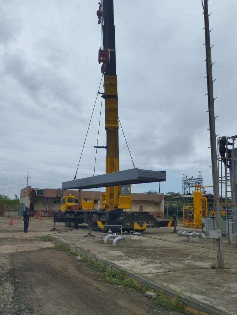 Grúa telescópica izando un enfriador, vista completa de la base a la pluma con operador